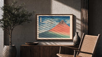 Red Mount Fuji with clouds print in a wood frame above a fluted sideboard beside an olive tree