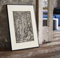 Adam and Eve in Eden print in a black frame leaning beside a vintage door on parquet