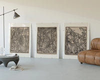 Death visiting medieval figures, three scenes three-panel set displayed beside a brown leather sofa
