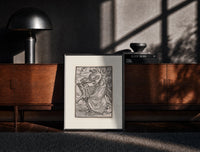 Black-framed Death leading a robed figure print on a moody console with designer coffee-table books
