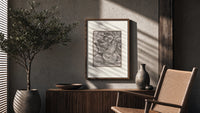Death leading a robed figure poster framed above a fluted sideboard beside an olive tree