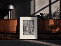 Black-framed Death and two noblewomen print on a moody console with designer coffee-table books