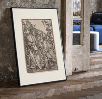 Death confronts two men outdoors print in a black frame leaning beside a vintage door on parquet
