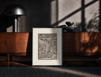 Black-framed Death with skeleton takes a child print on a moody console with designer coffee-table books