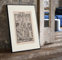 Death dancing with empress print in a black frame leaning beside a vintage door on parquet