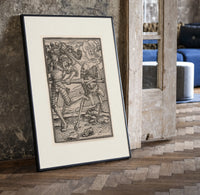 Death fighting armored nobleman print in a black frame leaning beside a vintage door on parquet