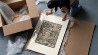 Death fighting armored nobleman framed print being unpacked from protective bubble wrap and a box