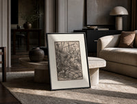 Death seizing merchant among cargo bales print in a black frame leaning on a travertine table in a sunlit lounge