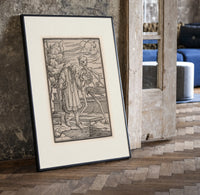 Death leading an old bearded man print in a black frame leaning beside a vintage door on parquet