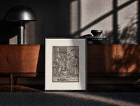 Black-framed Death visiting physician holding urine flask print on a moody console with designer coffee-table books