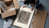 Death visiting physician holding urine flask framed print being unpacked from protective bubble wrap and a box