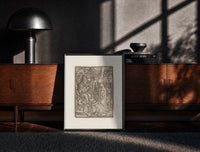 Black-framed Death visits the Pope crowning emperor print on a moody console with designer coffee-table books