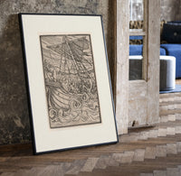 Ship in stormy sea with figures print in a black frame leaning beside a vintage door on parquet
