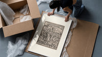 Death leading a bishop framed print being unpacked from protective bubble wrap and a box