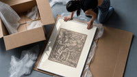 Death expelling Adam and Eve from Eden framed print being unpacked from protective bubble wrap and a box