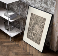 God enthroned above celestial globe poster in a black frame leaning beside a shelf in a raw-plaster loft