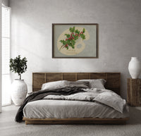 Holly Hearty Christmas Greetings print in a wood frame above a bed with a woven cane headboard
