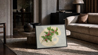 Holly Hearty Christmas Greetings print in a black frame leaning on a rug beside a beige sofa