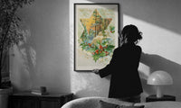 Holly With Every Good Wish print in a slim black frame being hung on a sunlit wall in a monochrome room