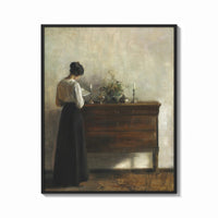 Framed woman reading at a dresser in a quiet interior vintage art print print shown as a bold statement piece on a clean…