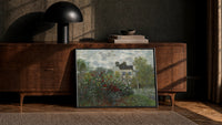 flowering garden with a cottage vintage art print print in a black frame leaning against a walnut console in lamplight