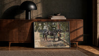 horse standing at a wooden fence in woods vintage art print print in a black frame leaning against a walnut console in…