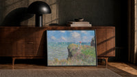 woman with red parasol on a flowering cliff vintage art print print in a black frame leaning against a walnut console in…
