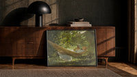 girl reading in a hammock vintage art print print in a black frame leaning against a walnut console in lamplight