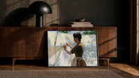 woman hanging laundry in sunlight vintage art print print in a black frame leaning against a walnut console in lamplight