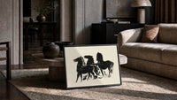 three horses in bold silhouette vintage art print print in a slim black frame leaning on a travertine coffee table