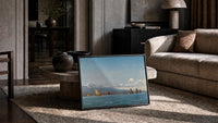 Mediterranean coastal scene with a volcano and sailboats vintage art print print in a slim black frame leaning on a…