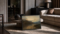 mountain lake at sunset with rowboat vintage art print print in a slim black frame leaning on a travertine coffee table