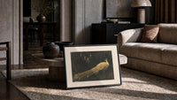 peacock in a moonlit garden vintage art print print in a slim black frame leaning on a travertine coffee table