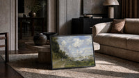 riverside park with sailboats vintage art print print in a slim black frame leaning on a travertine coffee table