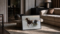 horse-drawn sledge racing through snow vintage art print print in a slim black frame leaning on a travertine coffee table