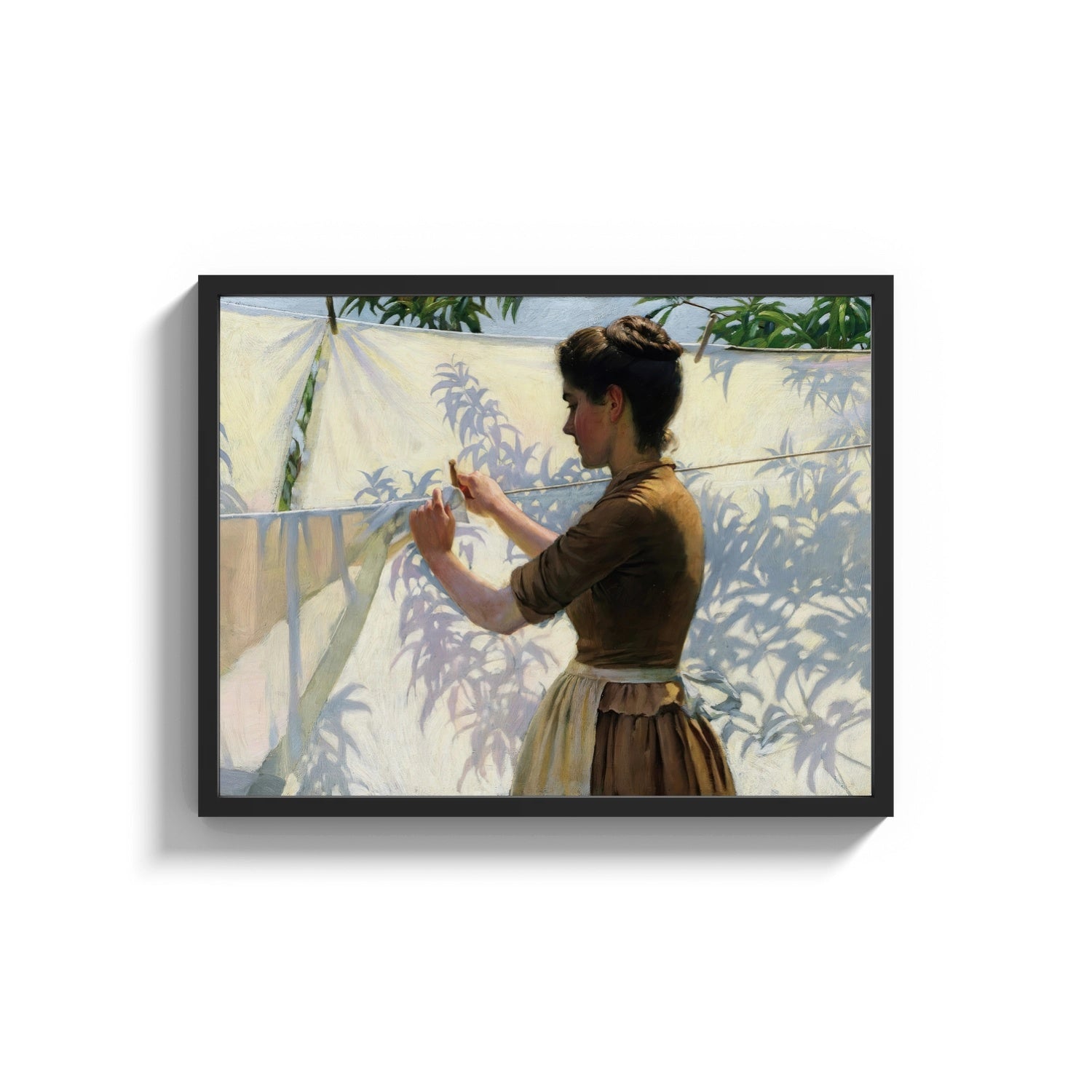 Framed woman hanging laundry in sunlight vintage art print print shown as a wide statement piece on a clean white wall