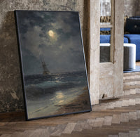tall ship at sea under full moon vintage art print print in a black frame leaning beside a vintage door on parquet