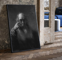 elderly bearded man in shadow vintage art print print in a black frame leaning beside a vintage door on parquet