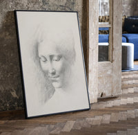 female face portrait study vintage art print print in a black frame leaning beside a vintage door on parquet