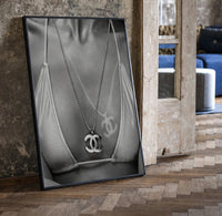 Chanel CC Necklace Black & White framed poster print in a black frame leaning beside a vintage door on parquet