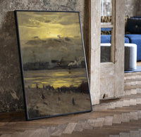 beach at sunset with silhouetted figures vintage art print print in a black frame leaning beside a vintage door on parquet