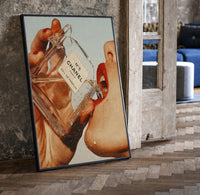 Luxury Fragrance Portrait framed poster print in a black frame leaning beside a vintage door on parquet