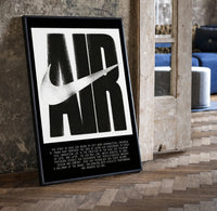 Nike Air History framed poster print in a black frame leaning beside a vintage door on parquet