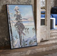 ice skaters on a frozen lake among snowy pines vintage art print print in a black frame leaning beside a vintage door on…