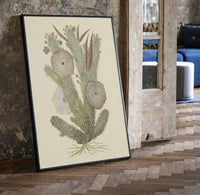 cactus with flowers vintage art print print in a black frame leaning beside a vintage door on parquet