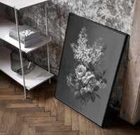 white lilac and roses bouquet vintage art print poster in a black frame leaning beside a shelf in a raw-plaster loft