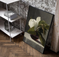 white peony in dark glass vase vintage art print poster in a black frame leaning beside a shelf in a raw-plaster loft