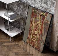 Klimt's Hygieia with gold serpent vintage art print poster in a black frame leaning beside a shelf in a raw-plaster loft