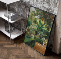 garden with palm trees and figures vintage art print poster in a black frame leaning beside a shelf in a raw-plaster loft