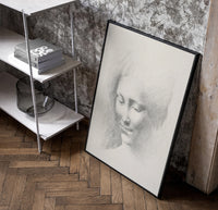 female face portrait study vintage art print poster in a black frame leaning beside a shelf in a raw-plaster loft